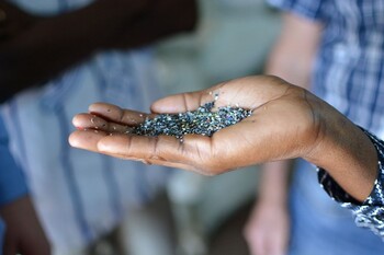 A hand holding plastic granulate.