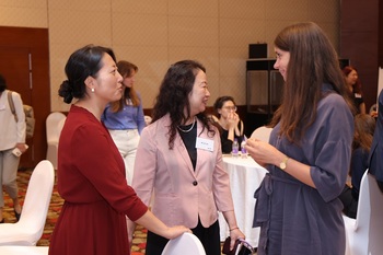 Three women chat at the IKI Networking Workshop 2024.